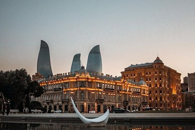 Baku City Sights Guided Night Walking Tour with Funicular - Clock Tower piano, Azneft Square, and Four Seasons luxury contrast